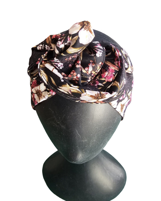 Floral headscarf on a mannequin head against a white background
