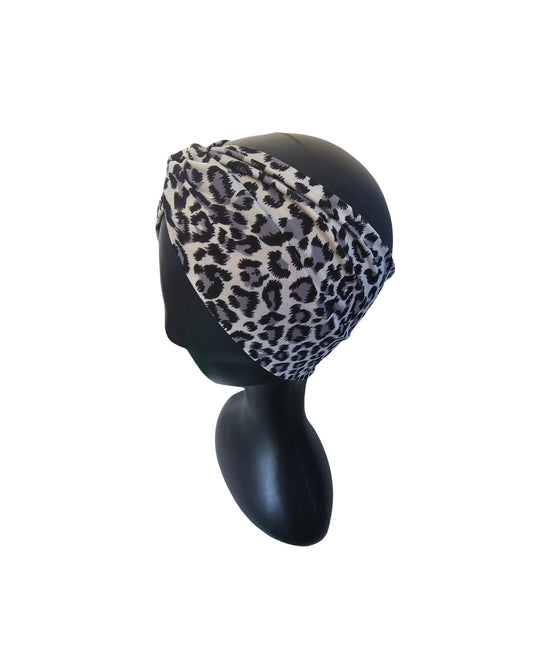 Leopard print headband on a mannequin head against a white background