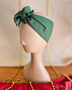 Side view of the Deck the Halls forest green wire head wrap with a rosette twist and wide fabric band.