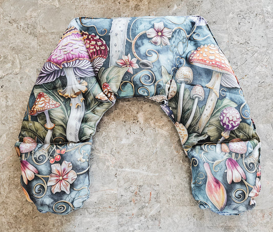 Hot and Cold Neck Pack with a detailed botanical and mycological print featuring mushrooms, flowers, and leaves on a textured gray stone background.