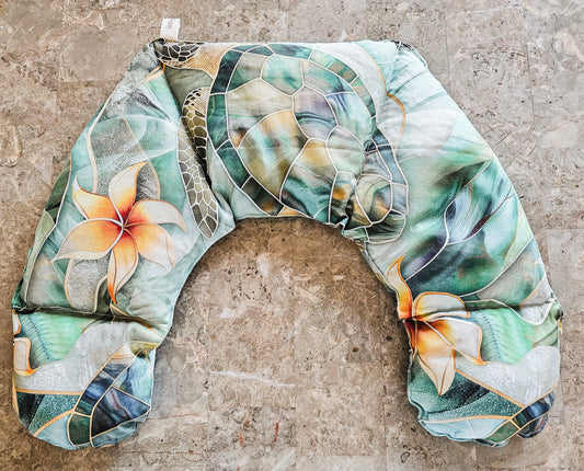Hot and Cold neck pack with a tropical floral and leaf pattern in shades of green, beige, and orange, laid flat on a textured stone surface.