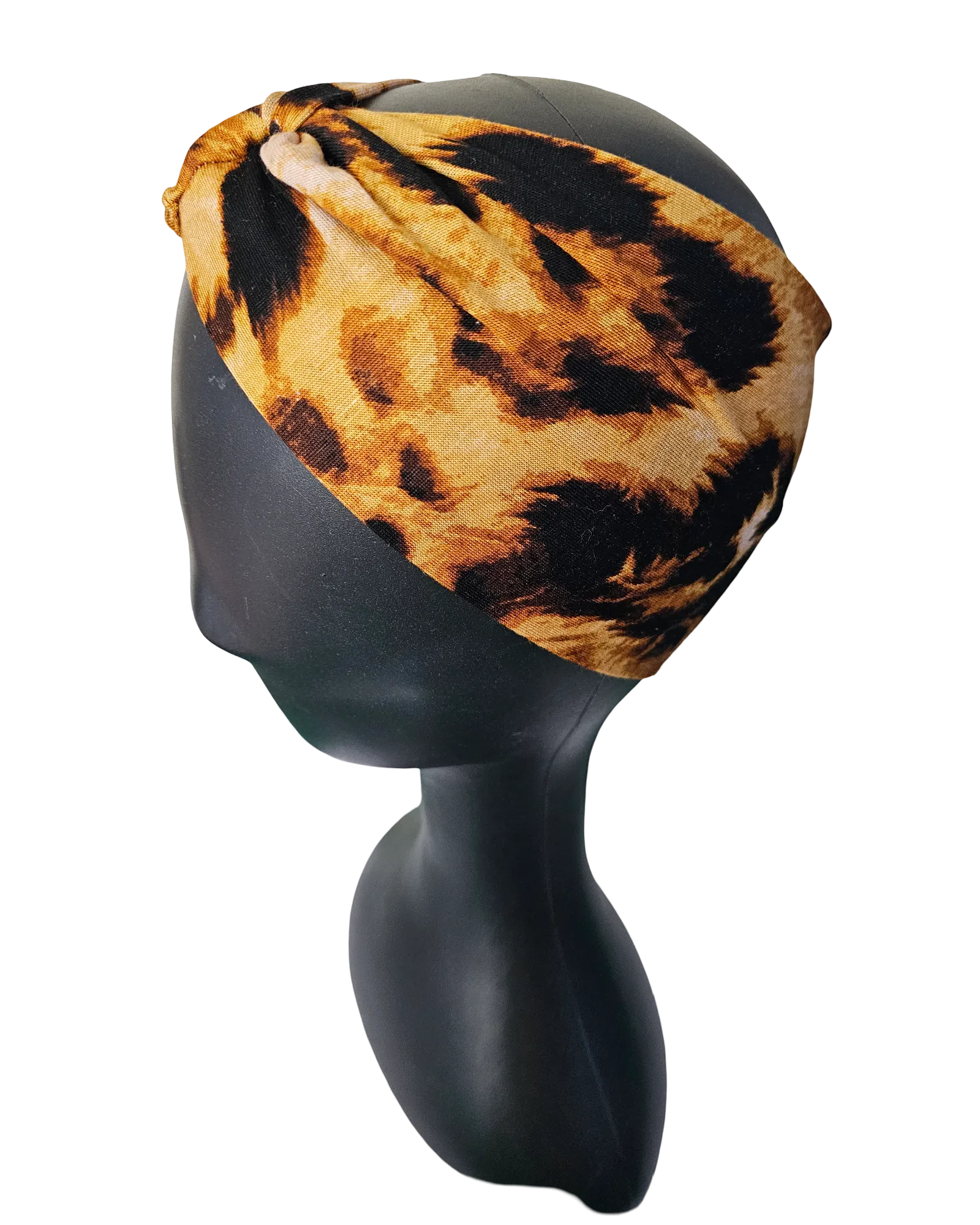 Leopard print headband on a black mannequin head against a white background