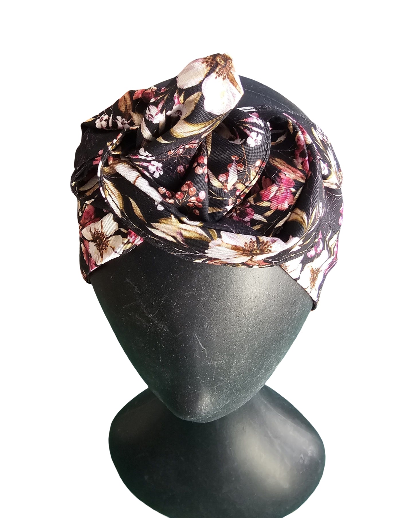 Floral headscarf on a mannequin head against a white background