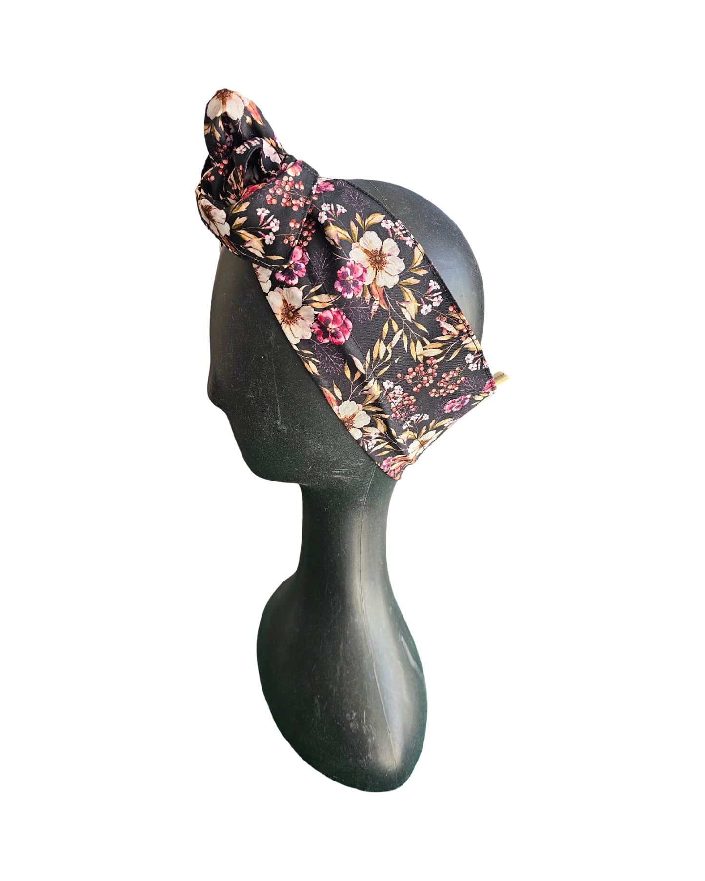 Floral headband on a mannequin head against a white background