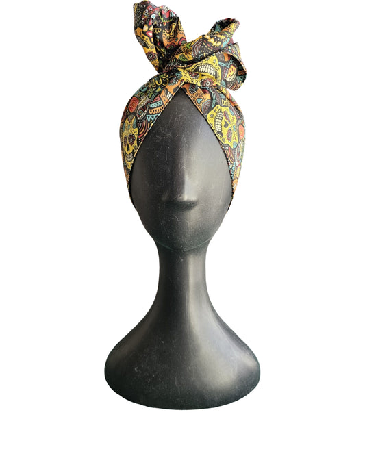 Colorful patterned headscarf on a mannequin head against a white background