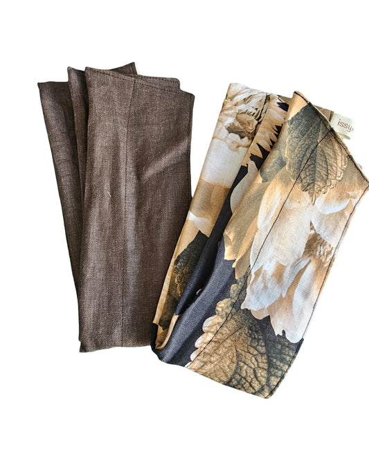 Set of brown fabric wire headbands and a floral patterned napkin on a white background