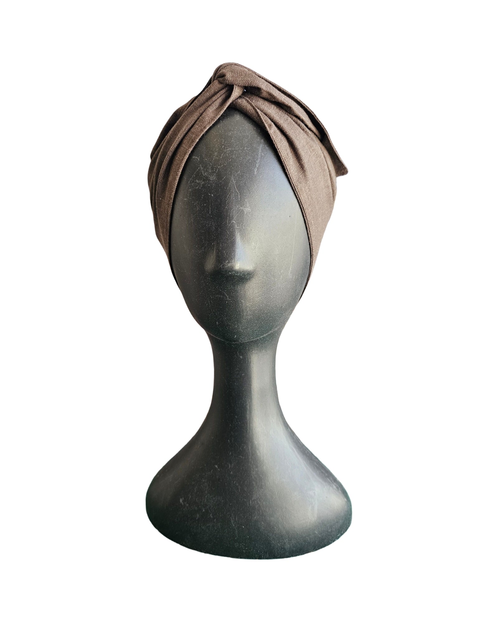 Brown headscarf on a mannequin head against a white background