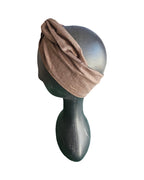 Brown headband on a mannequin head against a white background