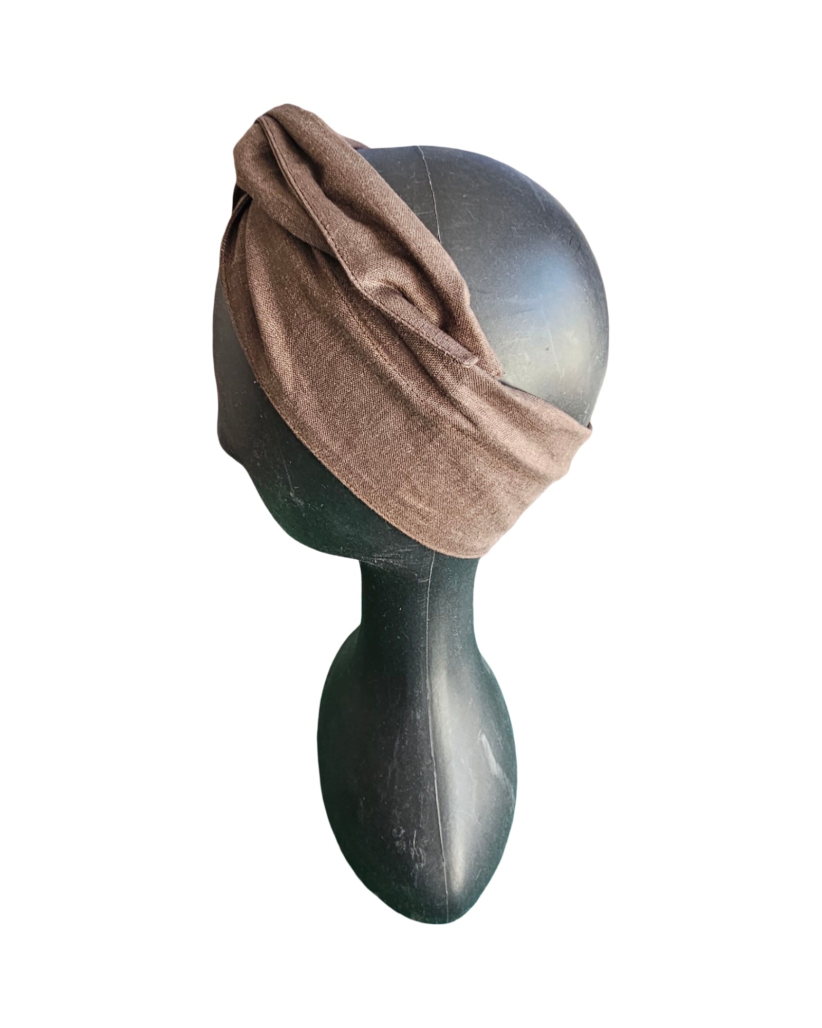 Brown headband on a mannequin head against a white background