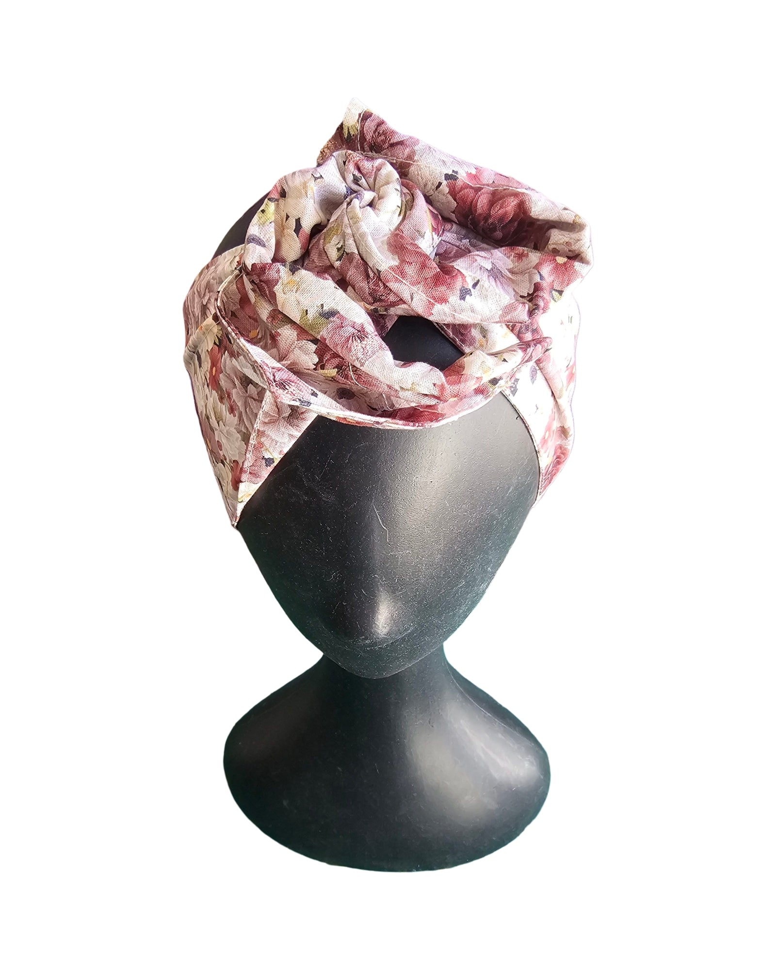 Floral headscarf on a mannequin head against a white background