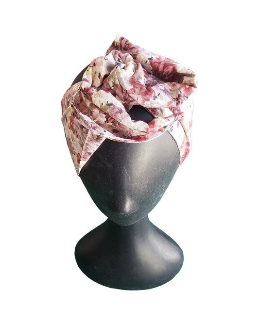 Floral headscarf on a mannequin head against a white background