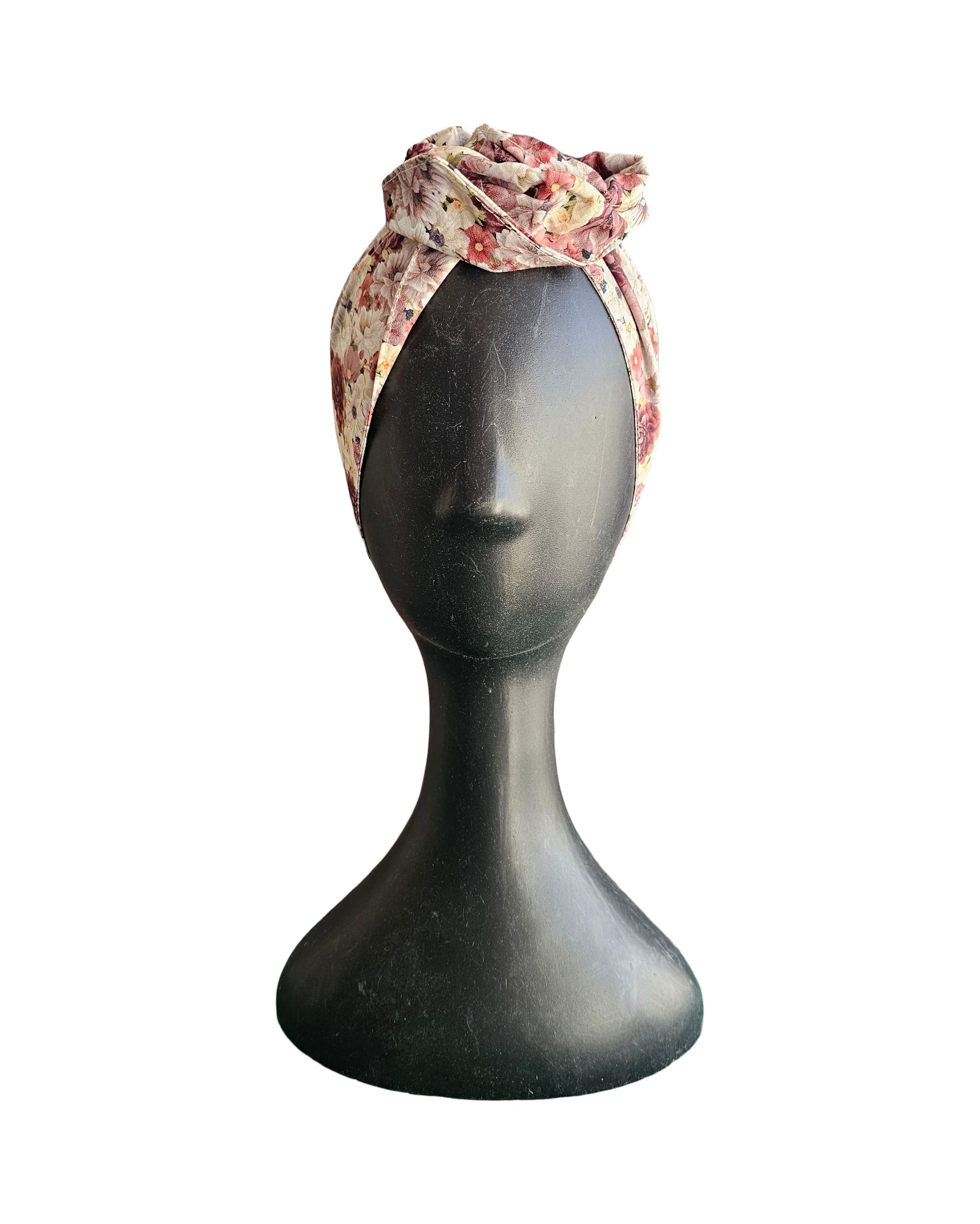 Floral headband on a mannequin head against a white background