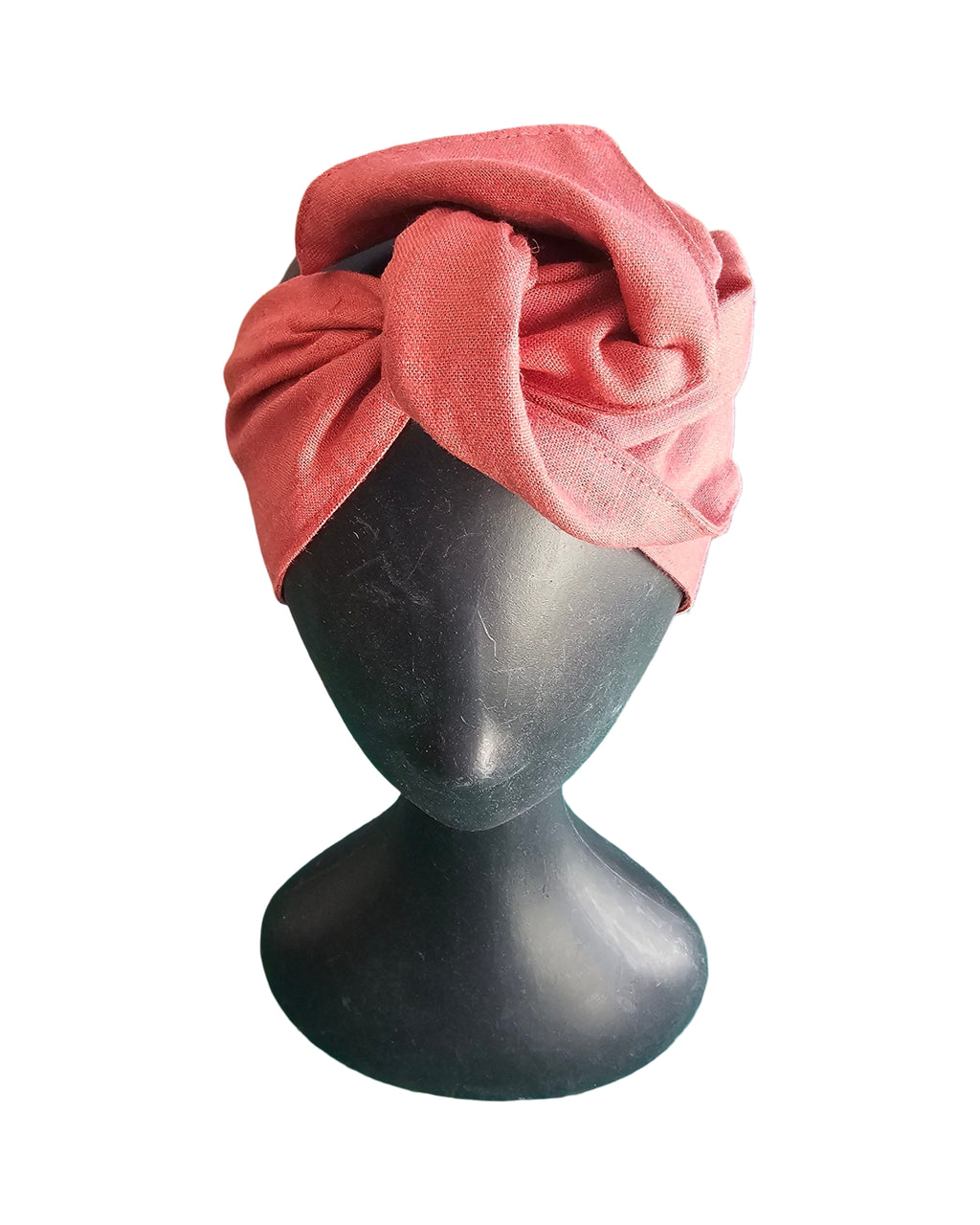 Pink turban on a mannequin head against a white background