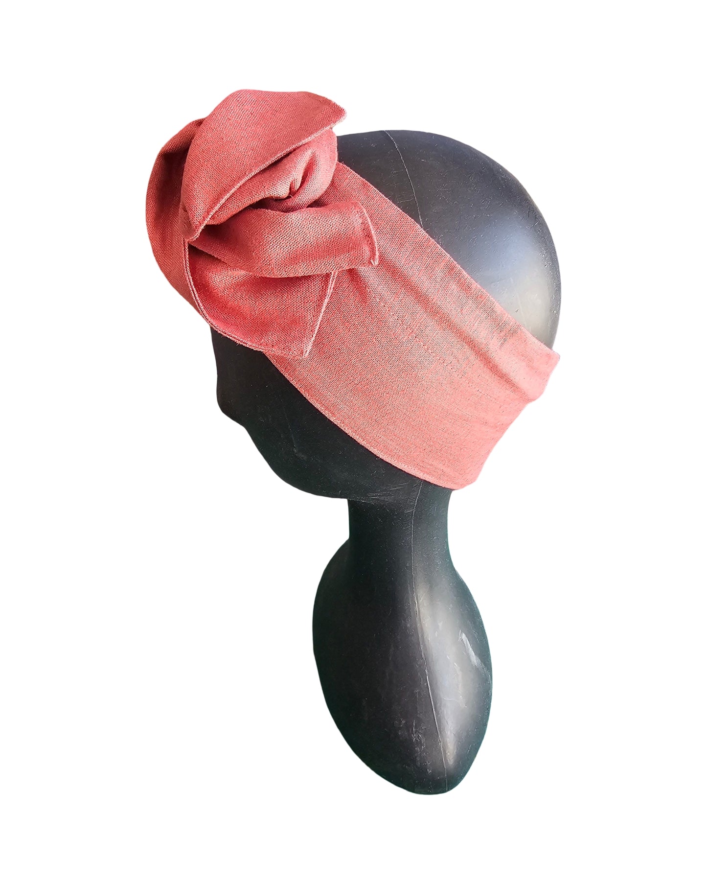 Pink headband on a mannequin head against a white background