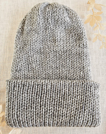 Knitted beanie on a textured beige background