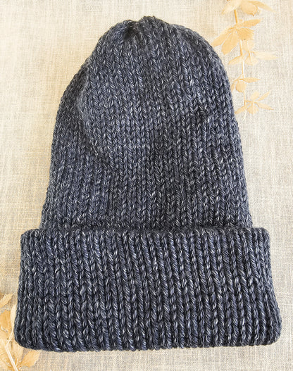 Knitted beanie on a textured beige background