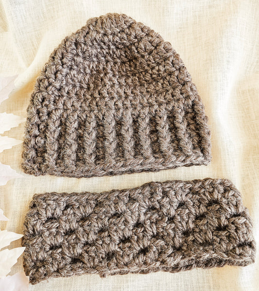 Brown crochet beanie and matching headband on a light fabric background