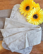 Flat View of a cream wire headwrap with sunflowers on wooden back drop