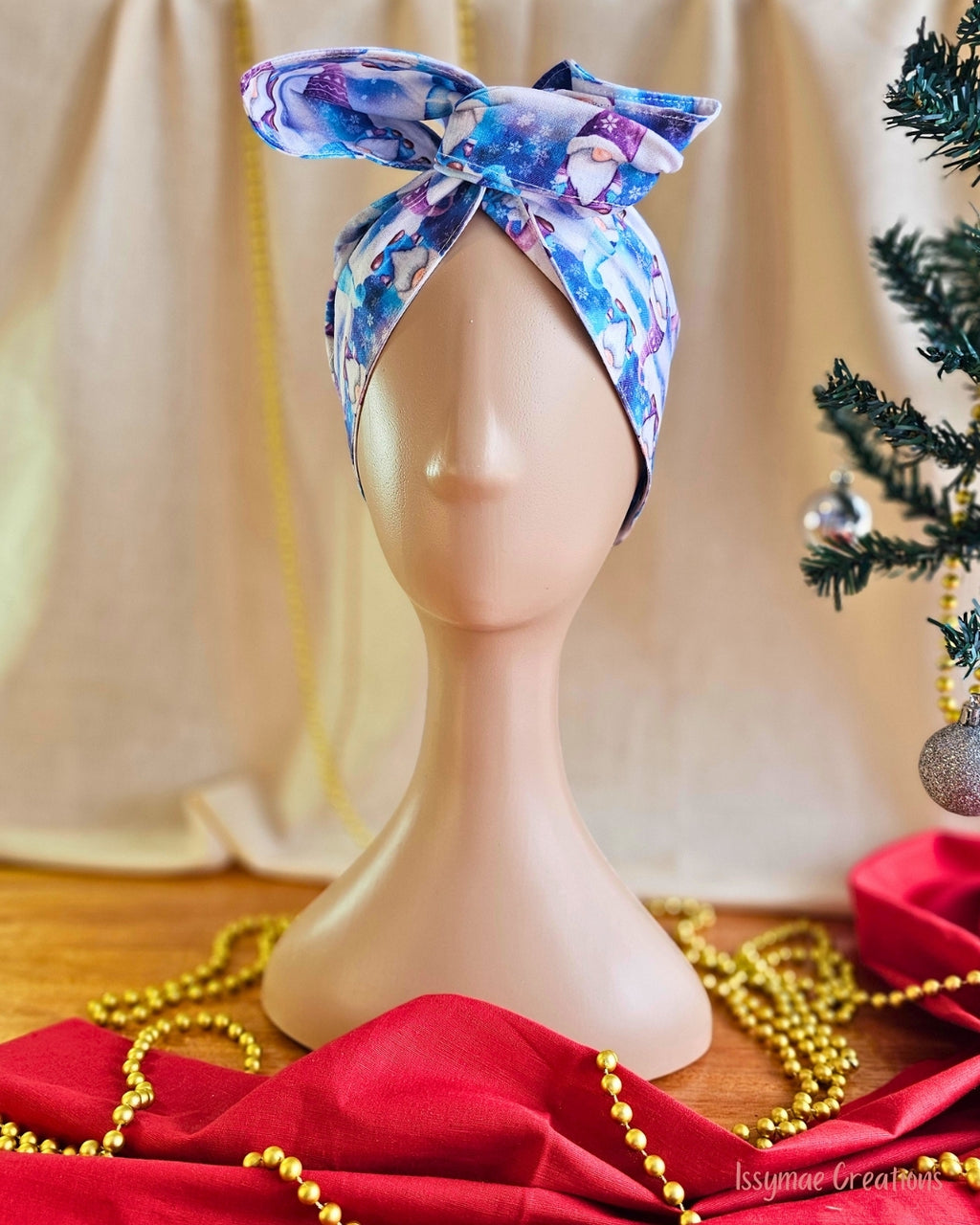 Gnome for the Holidays Christmas wire head wrap in blue and purple, styled in a bow on a mannequin.