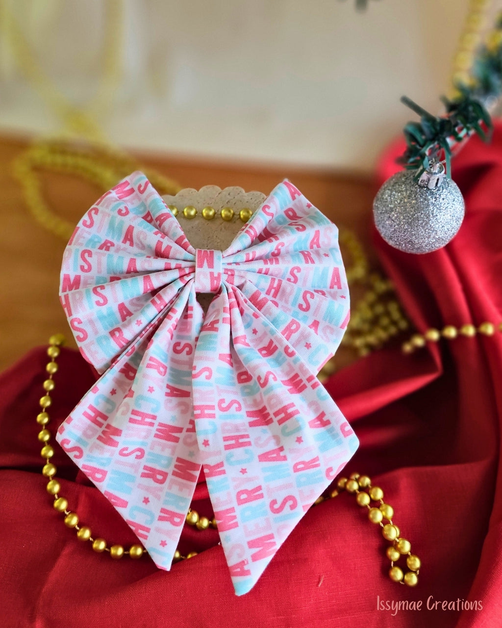 Pattern Christmas Hair Bow on a red and cream background