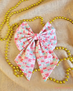 Christmas pattern hair bow on cream and gold beads background