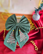 Bottle Green Hair Bow with embroidery on a red and gold back ground