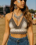Woman wearing a crochet top and denim shorts at an outdoor event