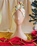 Koala Clause Christmas wire head wrap in pale yellow, styled with a twisted top knot on a mannequin.
