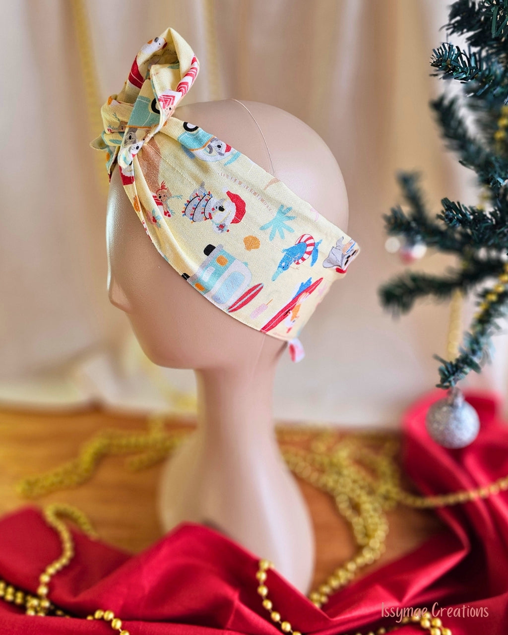 Side view of the Koala Clause wire head wrap showing a wide pale yellow band with koalas wearing Santa hats.