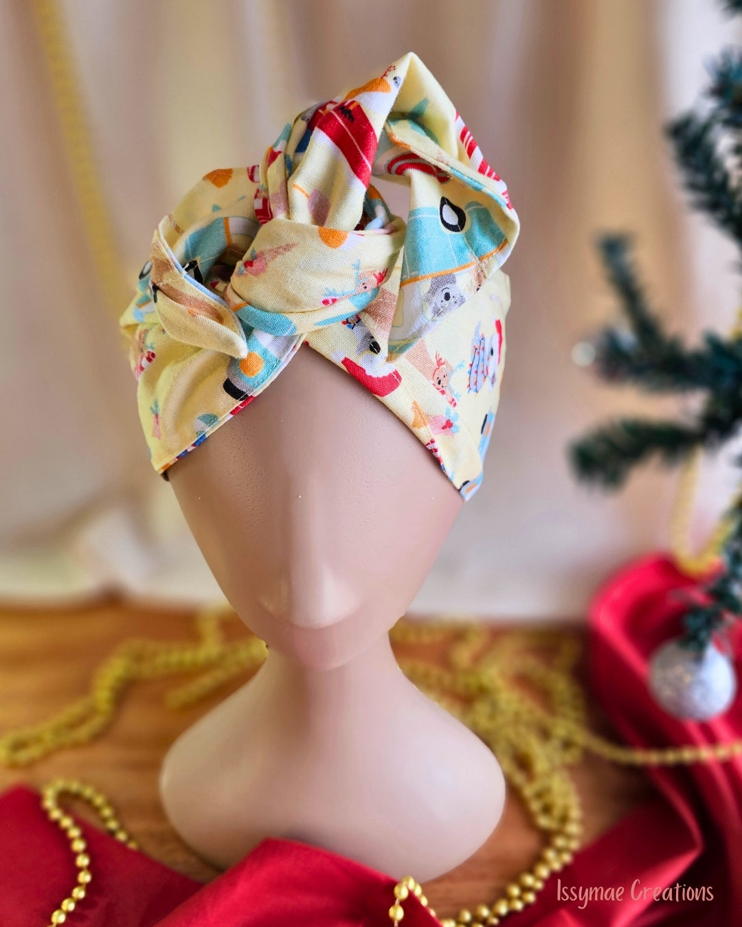 Close-up of the Koala Clause wire head wrap’s twisted knot, showing its colourful Australian Christmas print.