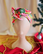 Close-up of the Merry Starburst wire head wrap’s twisted top knot and pink, red and green starburst pattern.