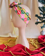 Side view of the Merry Starburst wire head wrap showing its wide, colourful patterned band on a mannequin.