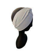 Gray headscarf on a mannequin head against a white background