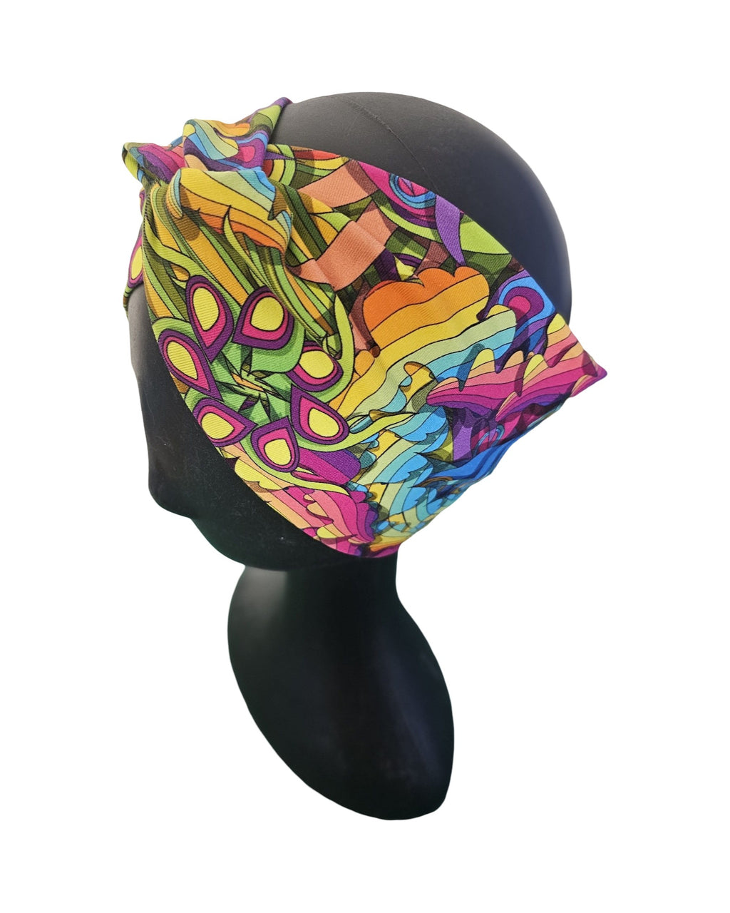 Colorful headscarf with abstract pattern on a mannequin head against a white background