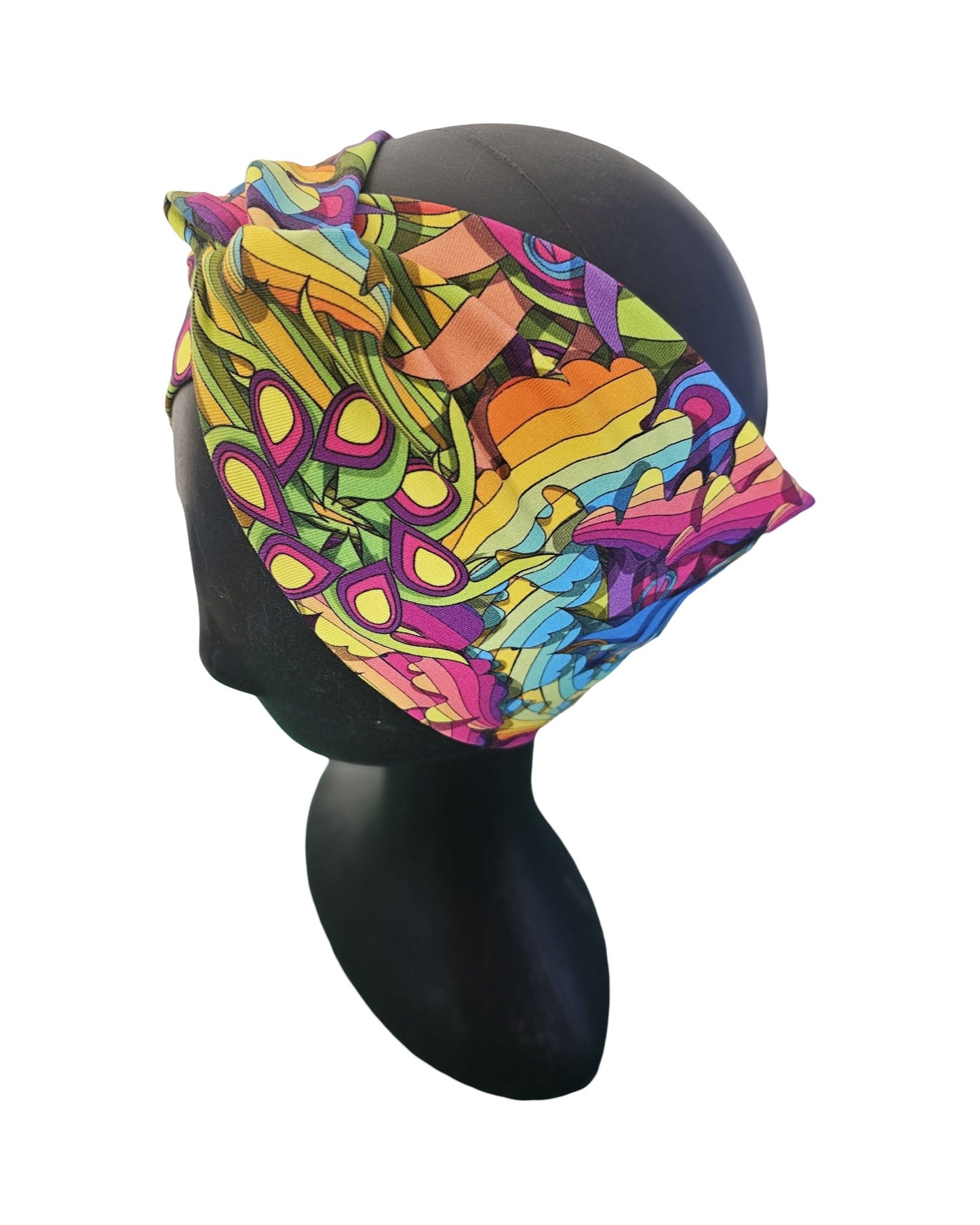 Colorful headscarf with abstract pattern on a mannequin head against a white background