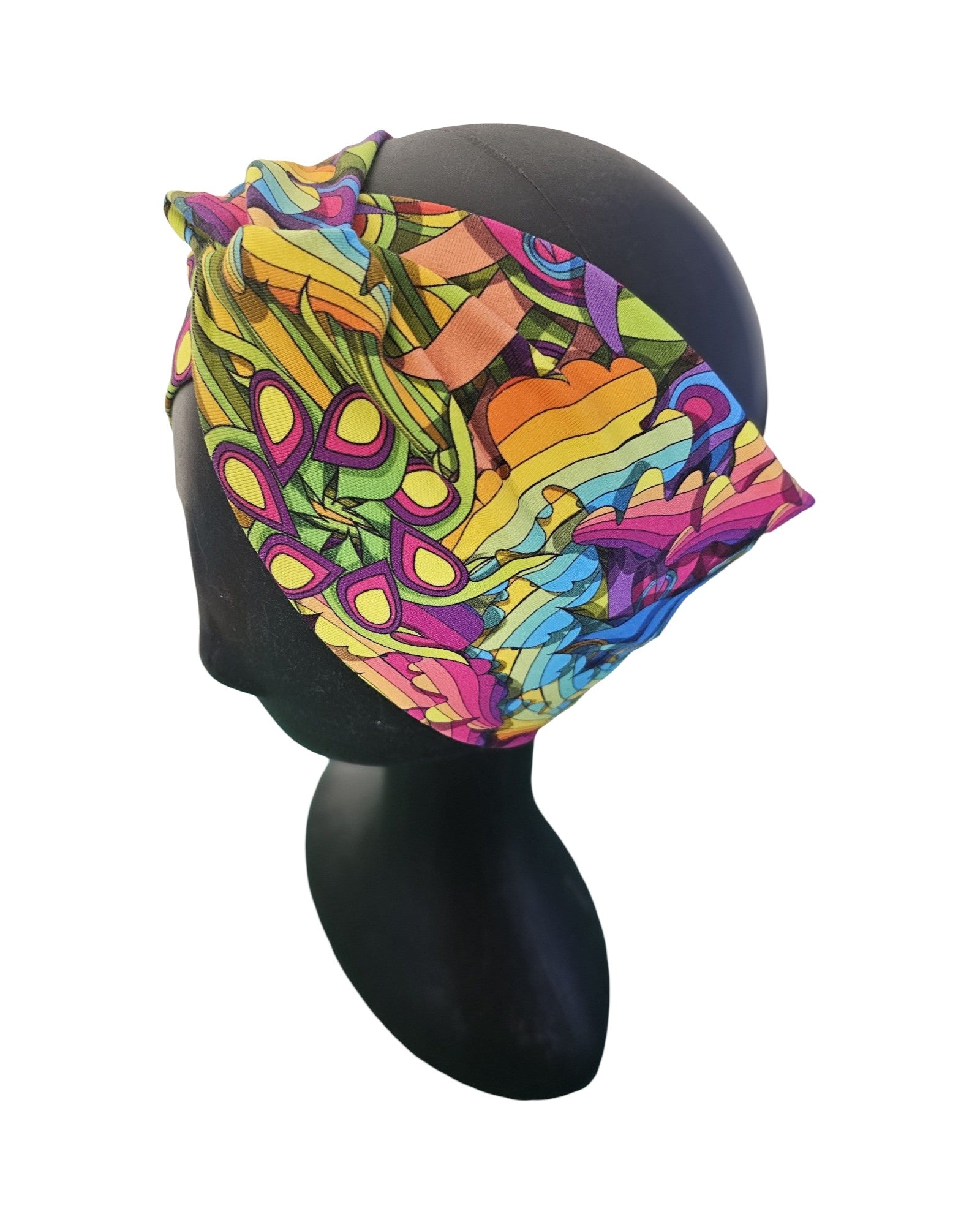 Colorful headscarf with abstract pattern on a mannequin head against a white background