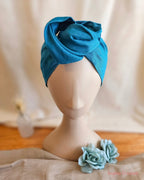 Ladies Teal wie head band with flowers and linen and wood back ground
