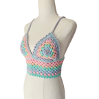 A multicolored crochet top displayed on a mannequin, featuring a geometric pattern with rainbow colors.