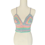 A multicolored crochet top displayed on a mannequin, featuring a geometric pattern with rainbow colors.