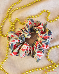 Snow Sage handmade Christmas scrunchie in sage green with Santas, snowmen and presents